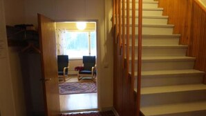 A staircase with wooden handrails leading to a landing. - Rantala by Interhome (Suonenjoki)