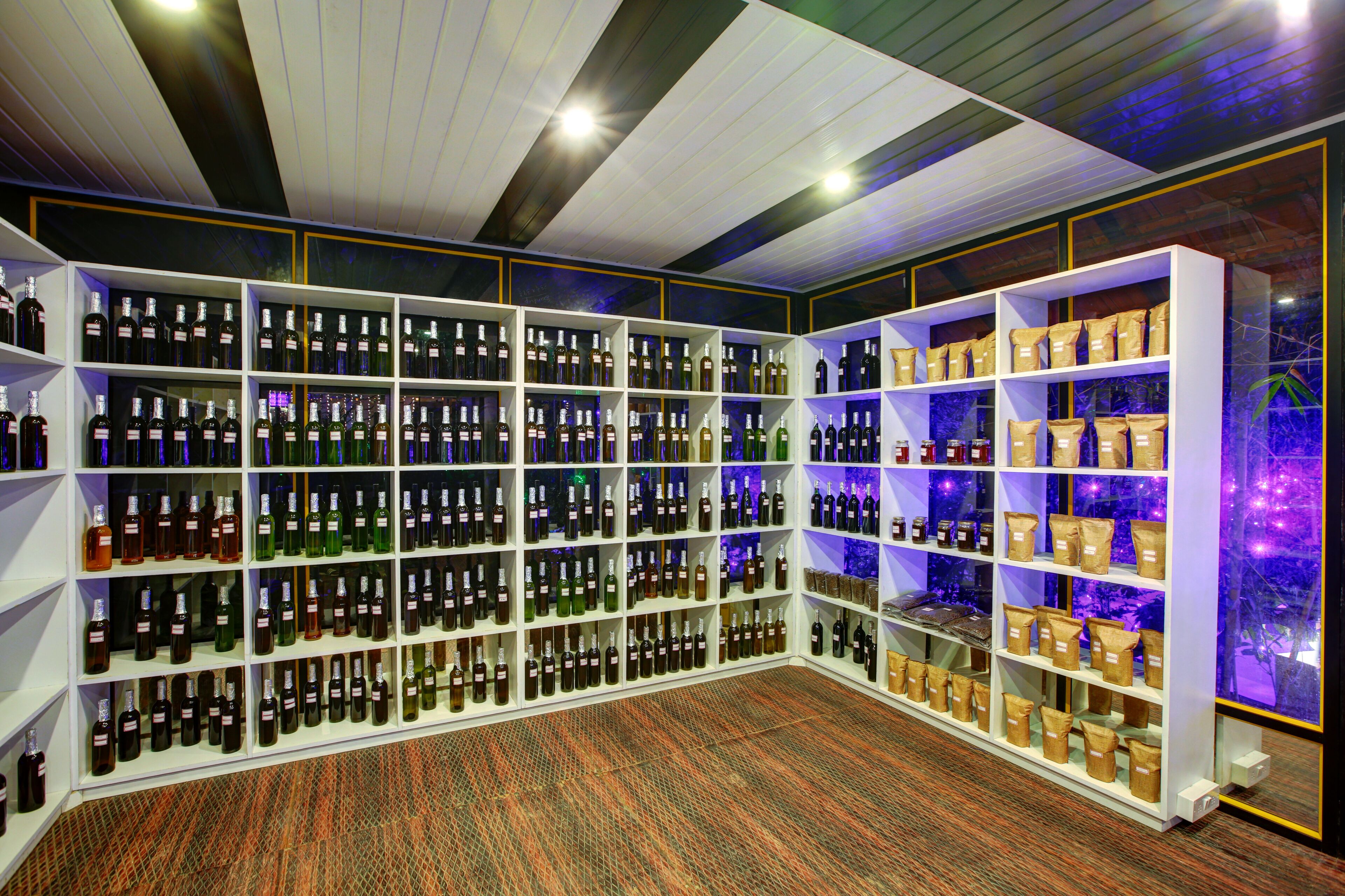 A wine cellar with shelves of wine bottles and bags of wine corks.