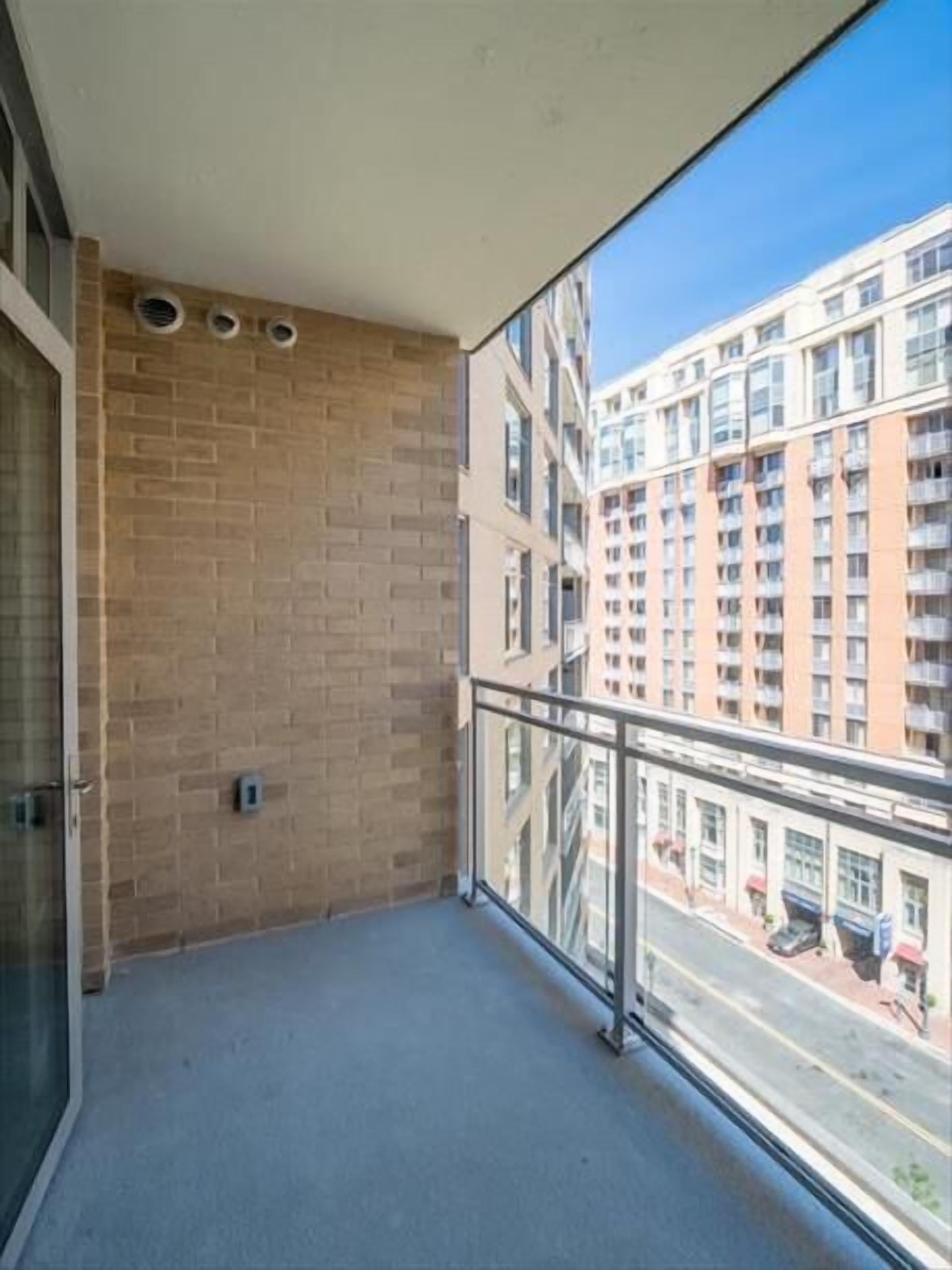 A balcony with a view of a multi-story building.