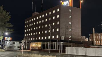 Een meerlaags gebouw met een bord waarop staat dat het een hotel is.