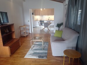 Relax in this inviting living space with a sofa, coffee table, and television.