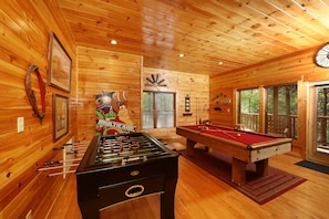 Relax and unwind in this inviting room, featuring a foosball table and pool table for social gatherings and leisure.