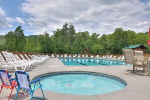 Relax by the pool surrounded by lush greenery and comfortable lounge chairs.