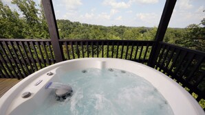 A hot tub on a wooden deck with a view of a forested landscape. - Pinnacle View 7A - Three Bedroom Chalet (Pigeon Forge)