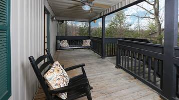 Relax on the covered porch with a comfortable rocking chair and take in the serene views of the surrounding landscape.