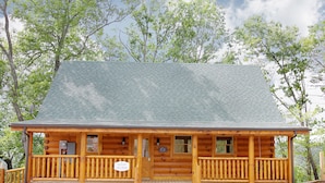 A log cabin with a porch and a small front entrance.