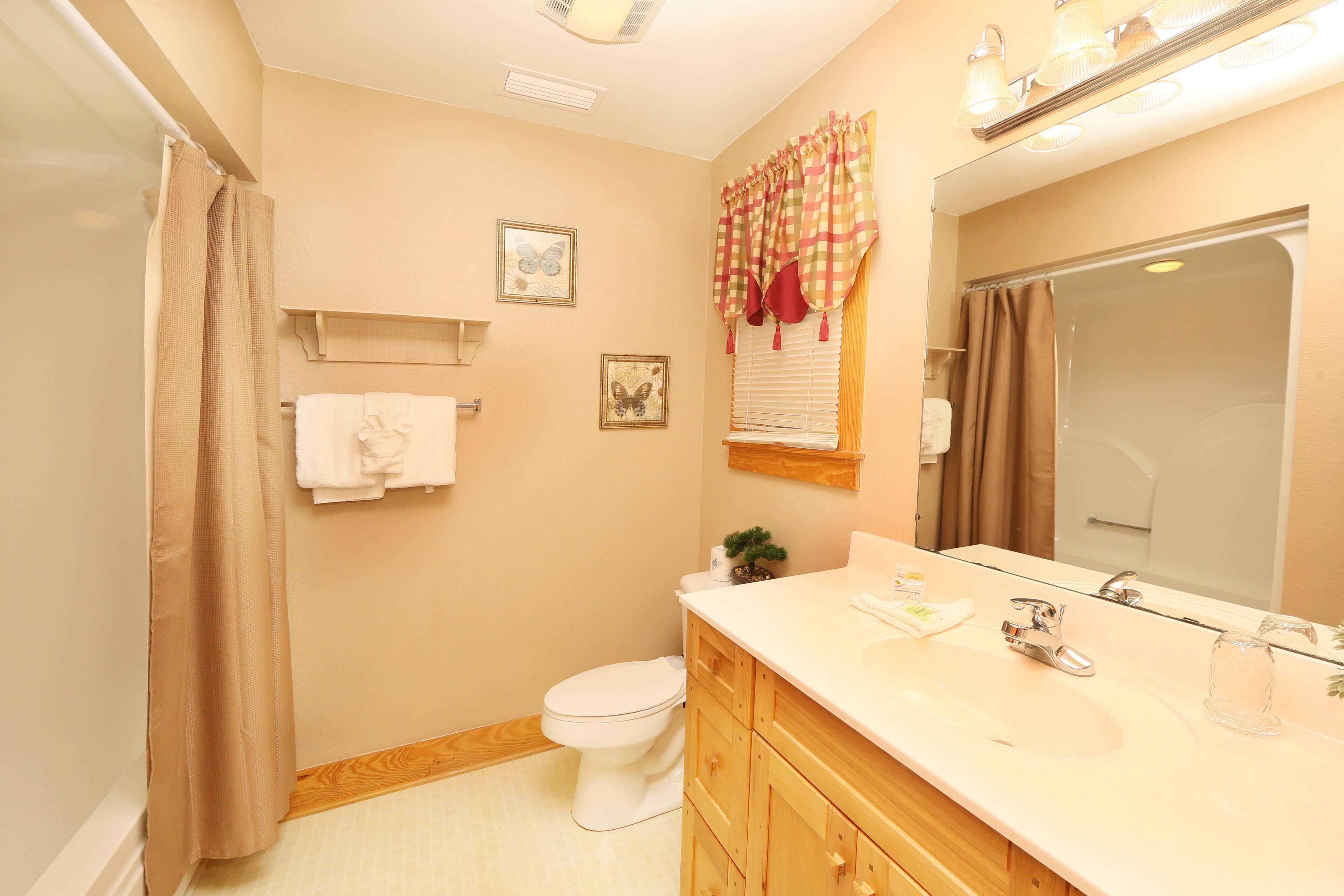 A bathroom with a toilet, sink, and shower.