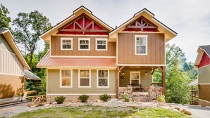 A two-story house with a front porch, stone steps, and a small front yard. - Marco Polo - Four Bedroom Chalet (Gatlinburg)