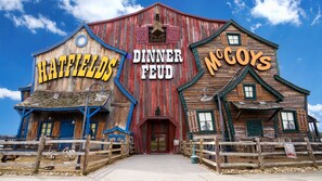 A rustic building with signs reading "RATFIELDS DINNER FEUD" and "McGoys".