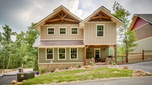 A two-story house with a front porch, stone foundation, and a mailbox labeled HP50.37. - Swimmin in the Smokies - Six Bedroom Chalet (Gatlinburg)