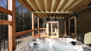 A hot tub with a wooden deck and a view of the forest. - Splash Time Cinema - Six Bedroom Chalet (Gatlinburg)
