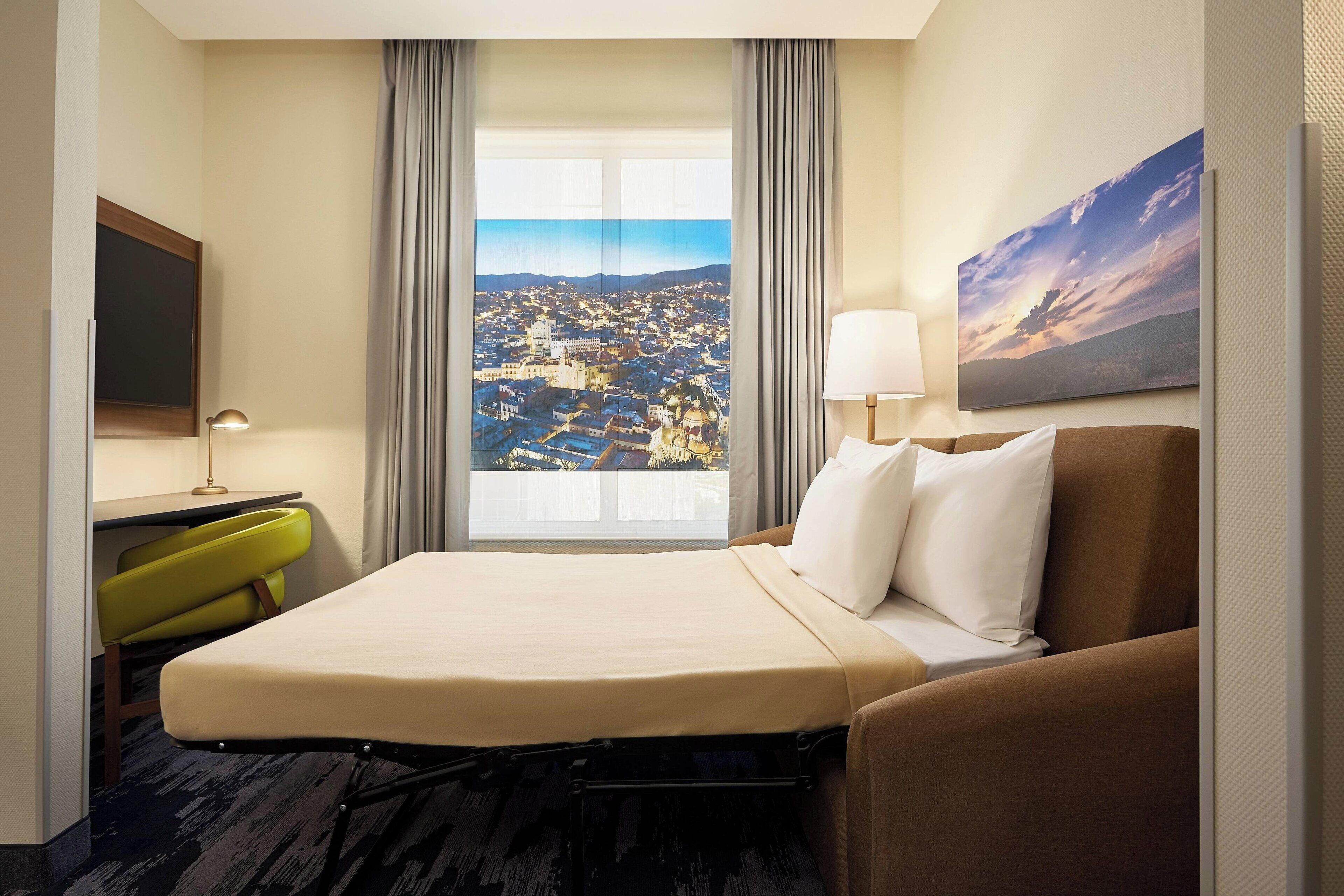 room, 1 king bed with sofa bed, city view | in-room safe, desk, laptop workspace, blackout curtains