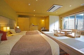 A hotel room with two beds, a dining table with chairs, a small kitchenette, and a large window. - HAKONE YUYADO ZEN (Hakone)