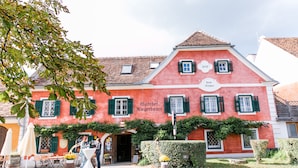 A red building with green shutters and a sign reading "Gasthof Riegerbauer." - Landgut Riegerbauer (Feistritztal)
