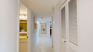 A hallway with a white door, a mirror, and a sink. - Gulf-Side Siesta Key Getaway with Beautiful Beach Views (Sarasota)
