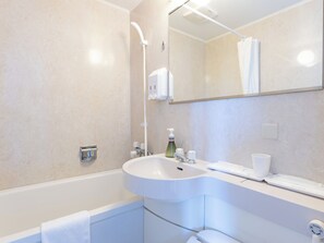 Combined shower/tub, free toiletries, hair dryer, slippers