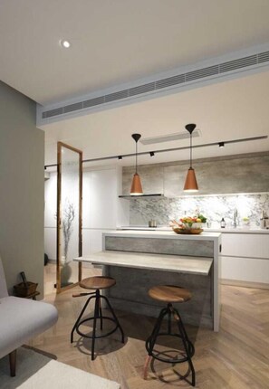 Enjoy cooking in this well-equipped kitchen with a central island, oven, and range hood.