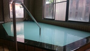 An indoor swimming pool with clear water, a metal ladder, and tiled walls. - Togurakamiyamada Onsen Sanpu So (Chikuma)