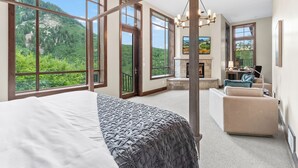 A spacious bedroom with large windows, a fireplace, and a balcony with a mountain view. - Mountain Lodge Overlooking Waterfall - Hot Tub, 5 bedroom, Unbelievable Views! (Sundance)