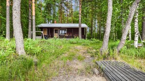 A cabin surrounded by trees with a gravel path leading to it. - Mäntyranta by Interhome (Savonlinna)