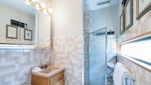 A bathroom with a mirror, sink, vanity, and a shower area. - Telluride Lodge #532 2 Bedroom Condo (Telluride)