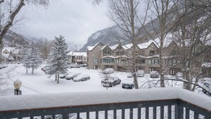 A snow-covered residential area with houses, a tree, and a mountain in the background. - 1 Block to Lift 7 | Walk to Downtown Telluride | Views, Hot Tub, Parking (Telluride)