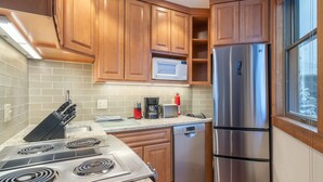 A kitchen with wooden cabinets, a stainless steel refrigerator, a microwave, a coffee maker, and a dishwasher. - 1 Block to Lift 7 | Walk to Downtown Telluride | Views, Hot Tub, Parking (Telluride)