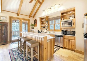 Dishwasher, coffee/tea maker, cookware/dishes/utensils, dining tables