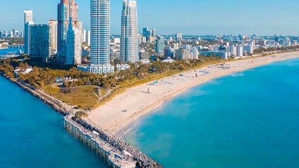A coastal cityscape with high-rise buildings, a beach, and a pier. - South of Fifth Beachside Condo 2Bed 1B, Pool, 2 Beach Chairs, 1 Umbrella (Miami Beach)