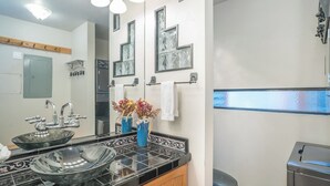 A modern bathroom with a large mirror, two sinks, and a toilet. - Telluride Lodge Condo 411 (Telluride)