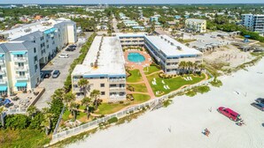 A resort with a pool, beach, and multiple buildings.