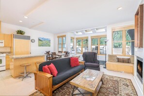 A modern living space with a kitchen, dining area, and seating area.