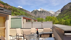 A terrace with a table and chairs, overlooking a mountainous landscape. - Willow 302 2 Bedroom/2 1/2 Bath Condo (Telluride)