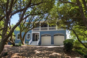 A two-story house with a front porch, a covered front entrance, and a garage.