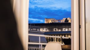 A view from a balcony with a clear sky and distant buildings. - Acropolis Panoramic View Exclusive Apartment | 3 Falirou str 11742 Athens (Athina)