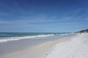 A beach with white sand and clear blue water. - Fall Specials Available! Pet Friendly! Steps to white sandy beaches and the bay!  Discounts applied for stays longer than 7 days and 30 days! (Bradenton Beach)