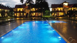 A hotel with a swimming pool and multiple guest rooms. - Lotus Seaview Beach Resort (Bandar Penawar)