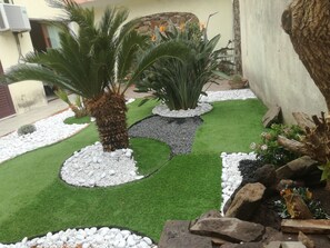 Stroll through a serene garden oasis surrounded by lush greenery and decorative elements.