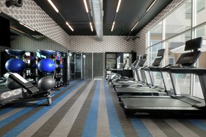 A gym with treadmills, exercise balls, and weight machines. - Aloft by Marriott Dallas Euless (Euless)