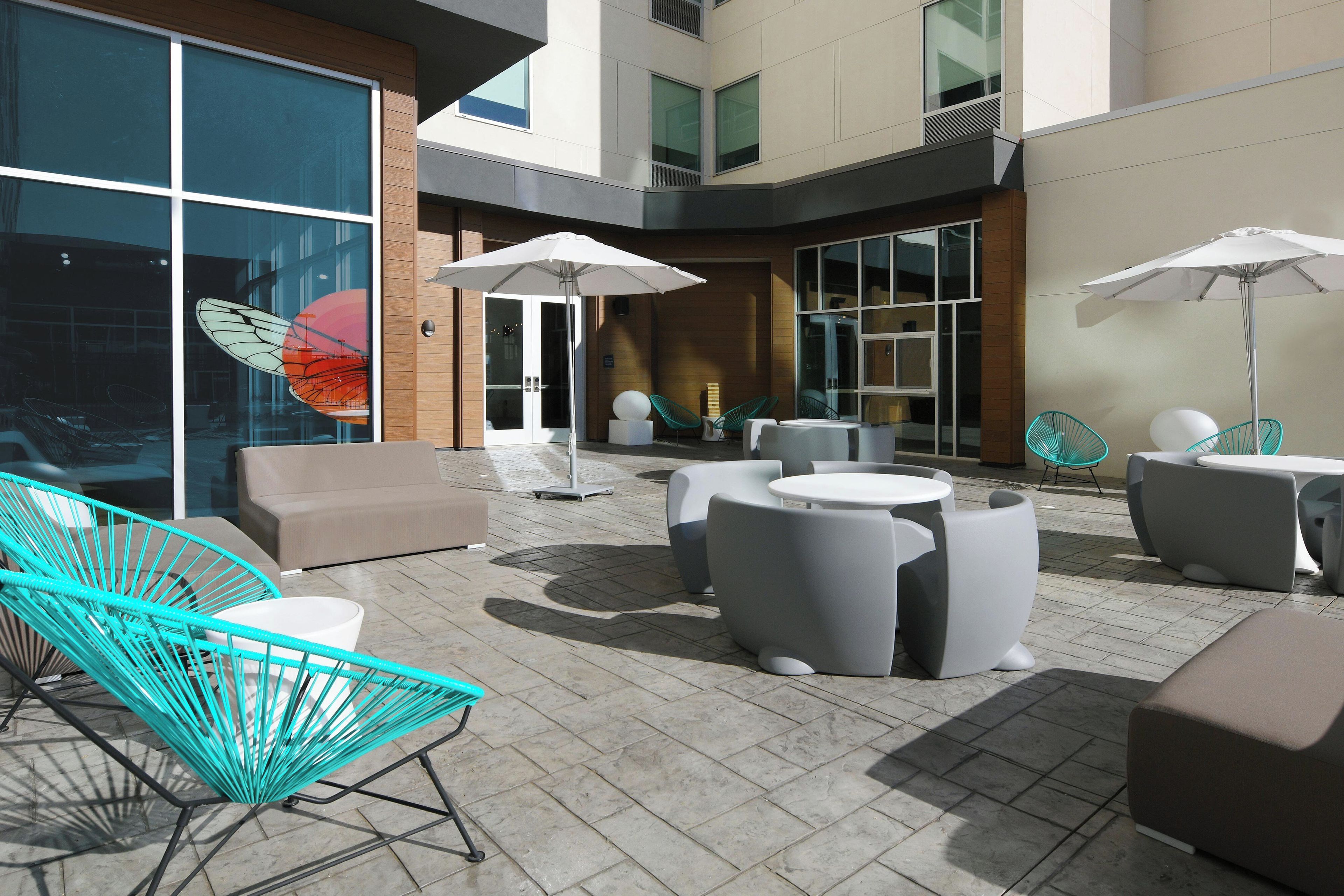 An outdoor seating area with modern furniture and umbrellas.