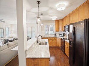 Dishwasher, coffee/tea maker, cookware/dishes/utensils, dining tables