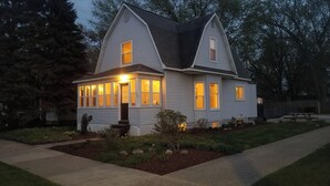 A two-story house with a gabled roof, multiple windows, and a front porch. - 3-bedroom vacation home - perfect for Tulip Time or Hope College Events! (Holland)