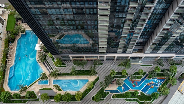 A high-rise building with multiple swimming pools and landscaped areas. - NES House - Riverview Apartment (Ho Chi Minh City)