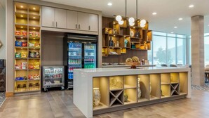 A modern kitchen with built-in appliances, a central island with storage, and a view of the outdoors. - Holiday Inn Express Bettendorf Davenport NE by IHG (Bettendorf)