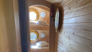 A narrow wooden hallway with a bunk bed room at the end. - Belle Epoque Trailer of Saint-Pardoux 63440 2 places (Saint-Pardoux)