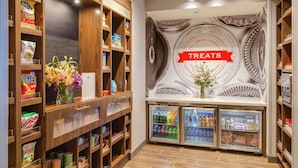 A bakery section with shelves of baked goods and refrigerated treats.
