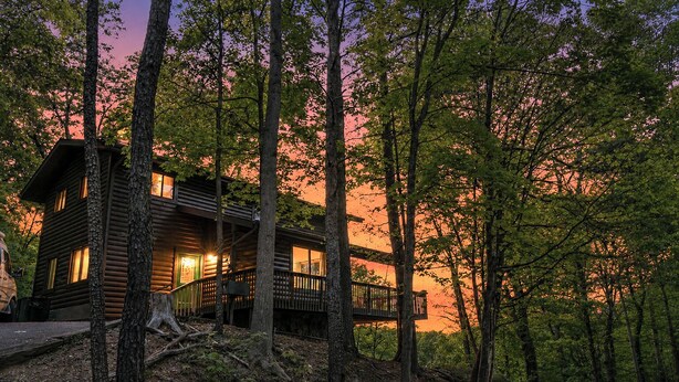 A log cabin with a deck, surrounded by trees. - Enjoy Starry Nights, Views, Privacy & Woods- Hot Tub, Game Room, Dog-Friendly (Gatlinburg)