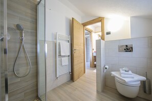 Een douche, een haardroger, een bidet, handdoeken