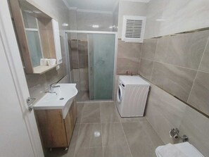 Apartment, 2 Bedrooms | Bathroom | Shower, free toiletries, hair dryer, slippers