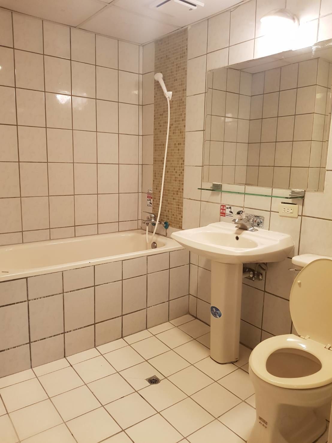A bathroom with a bathtub, sink, and toilet.